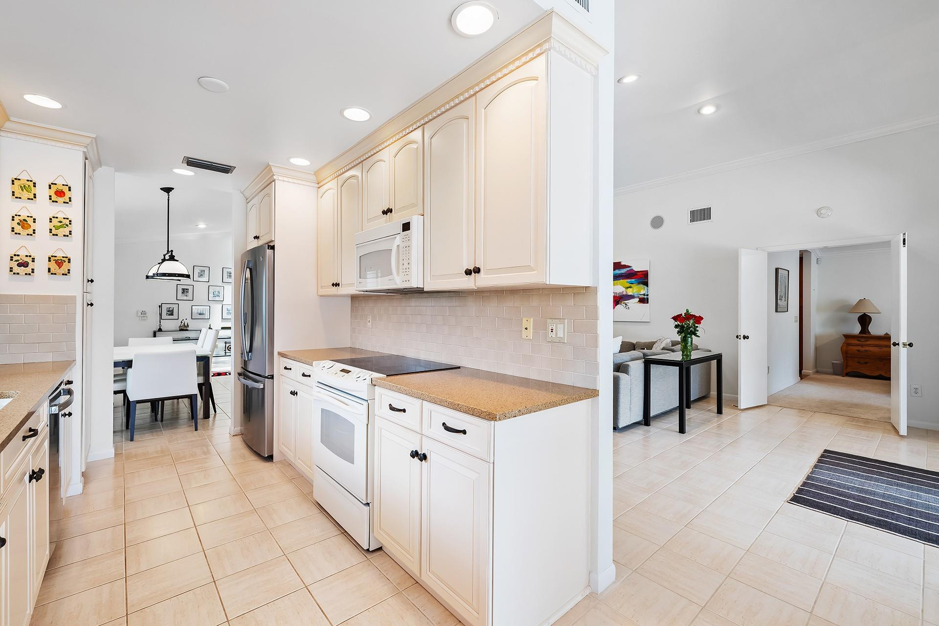 10344 Sunset Bend Drive Boca Raton, FL 33428 - Photo 12 of 32 a kitchen with stainless steel appliances a stove a sink and a refrigerator