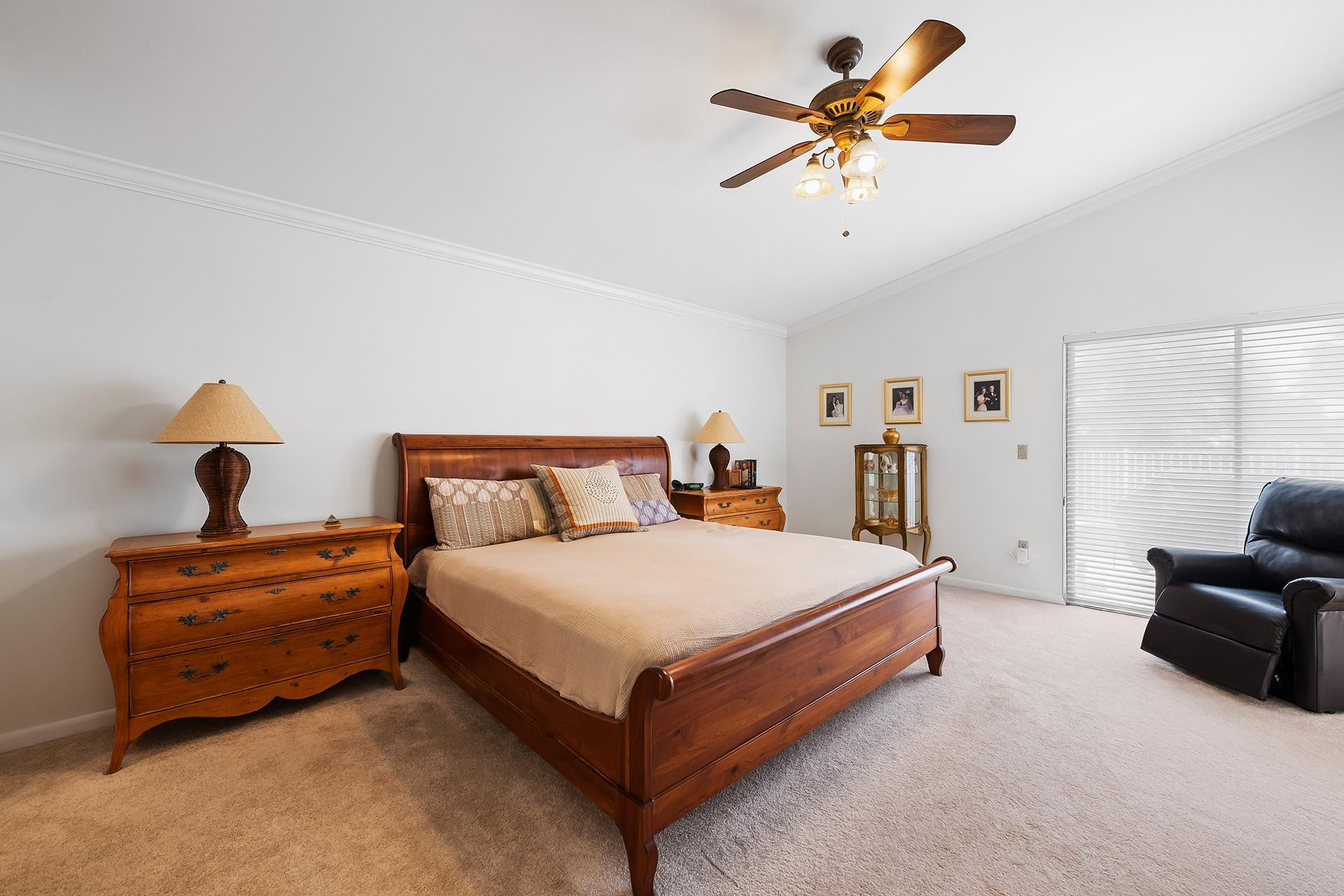 10344 Sunset Bend Drive Boca Raton, FL 33428 - Photo 15 of 32 a spacious bedroom with a bed and a chandelier