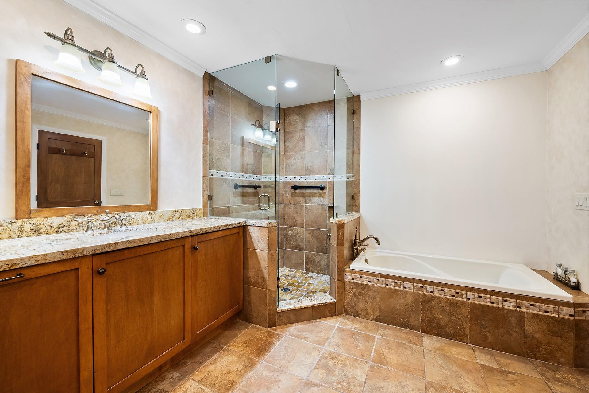 10344 Sunset Bend Drive Boca Raton, FL 33428 - Photo 16 of 32 a spacious bathroom with a tub sink and mirror
