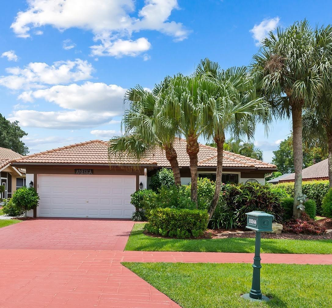 10344 Sunset Bend Drive Boca Raton, FL 33428 - Photo 2 of 32 a front view of a house with a yard
