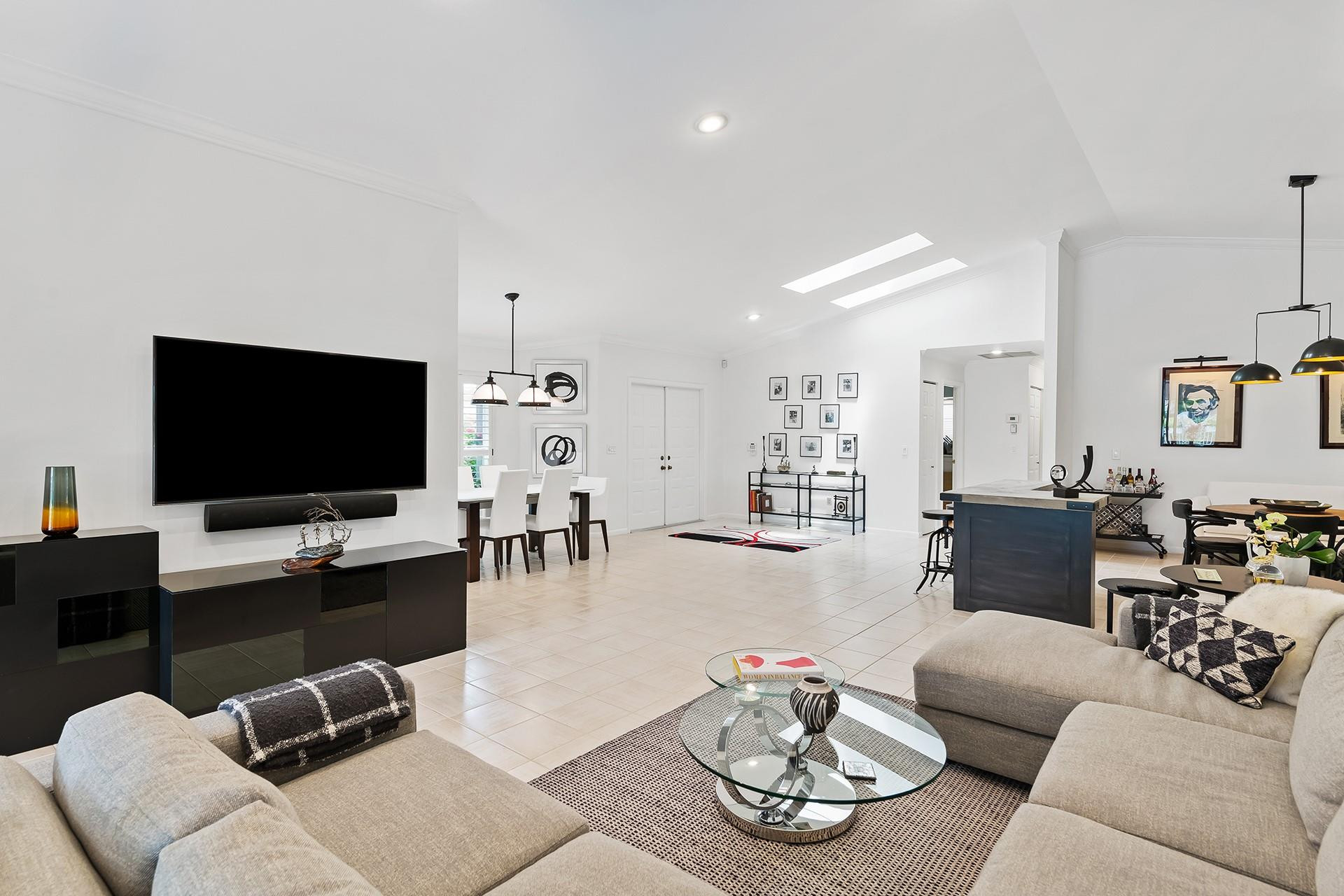 10344 Sunset Bend Drive Boca Raton, FL 33428 - Photo 4 of 32 a living room with furniture and a flat screen tv