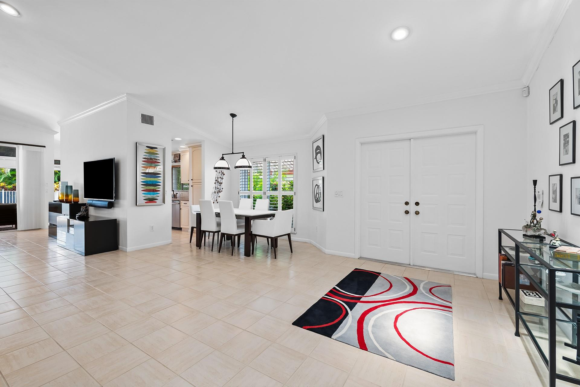 10344 Sunset Bend Drive Boca Raton, FL 33428 - Photo 6 of 32 a room with furniture a flat screen tv and a kitchen