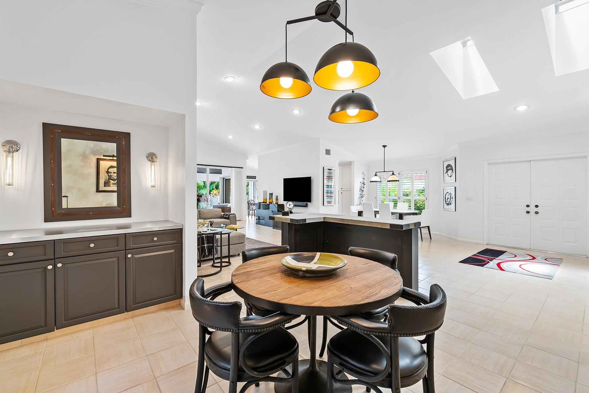 10344 Sunset Bend Drive Boca Raton, FL 33428 - Photo 8 of 32 a view of a dining room and kitchen with furniture