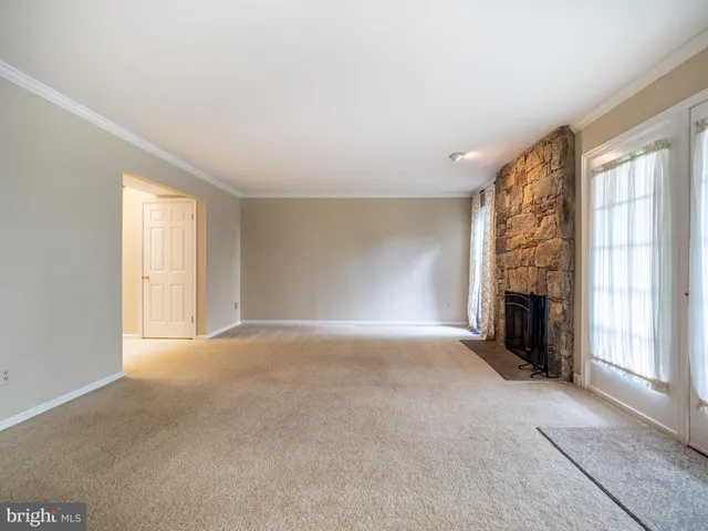 a kitchen with stainless steel appliances granite countertop a stove top oven a sink dishwasher and white cabinets with wooden floor