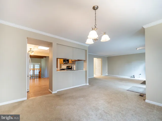 a kitchen with stainless steel appliances granite countertop a stove top oven a sink dishwasher and a refrigerator with wooden floor