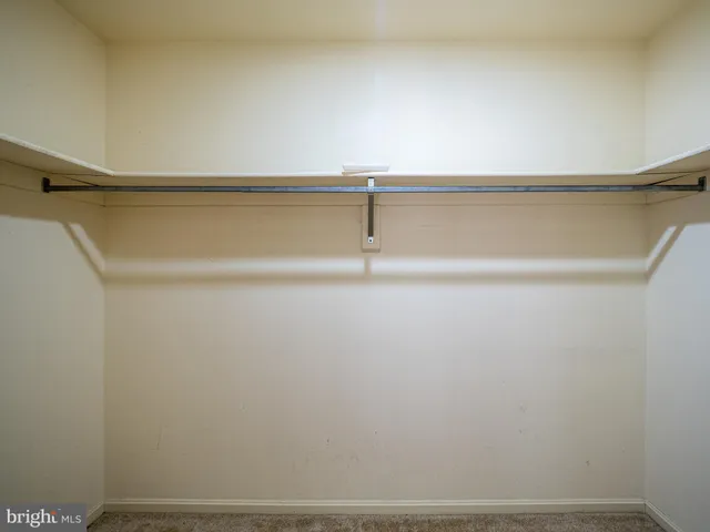 a bathroom with a granite countertop toilet a sink and a shower