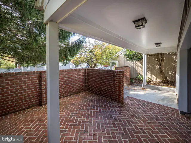 a view of a room with wooden floor and iron stairs