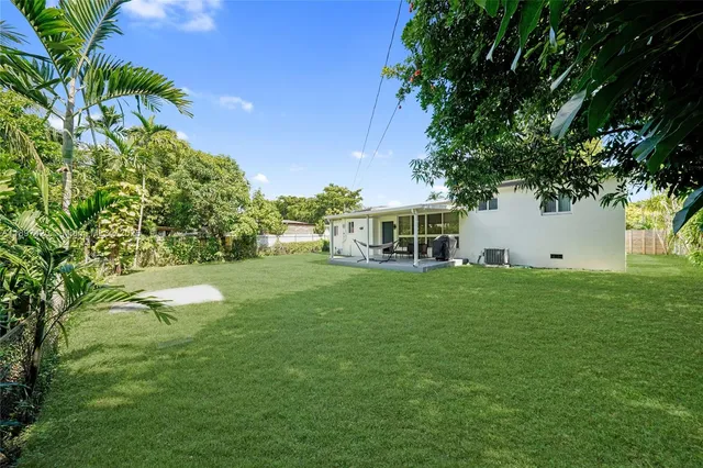 a view of a house with a backyard