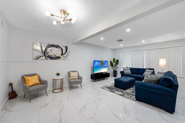 a living room with furniture a couch and chandelier