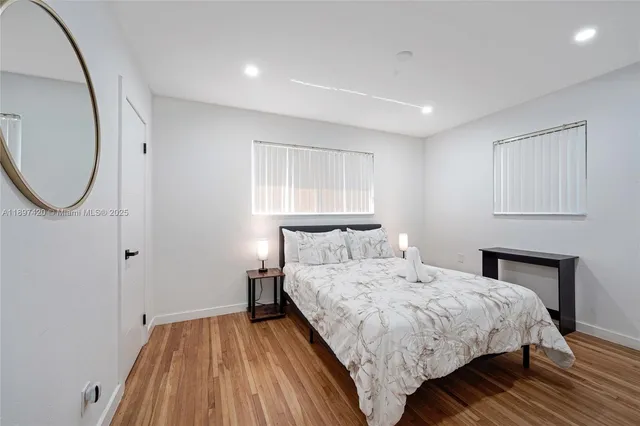 a bedroom with a bed and a mirror