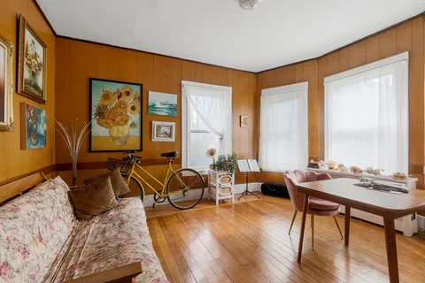 a living room with furniture and large windows