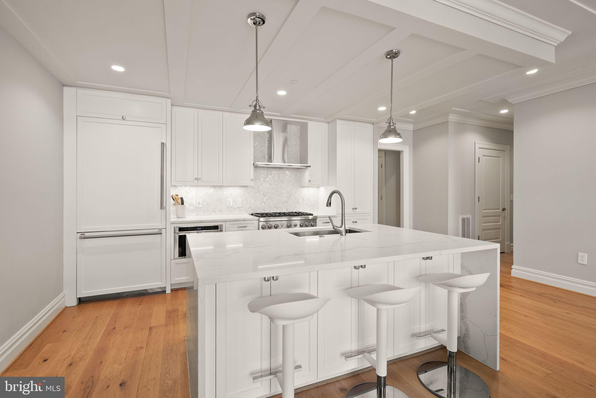 6900 Fleetwood Road, Unit 415 McLean, VA 22101 - Photo 11 of 51 a kitchen with stainless steel appliances kitchen island granite countertop a table chairs and a refrigerator