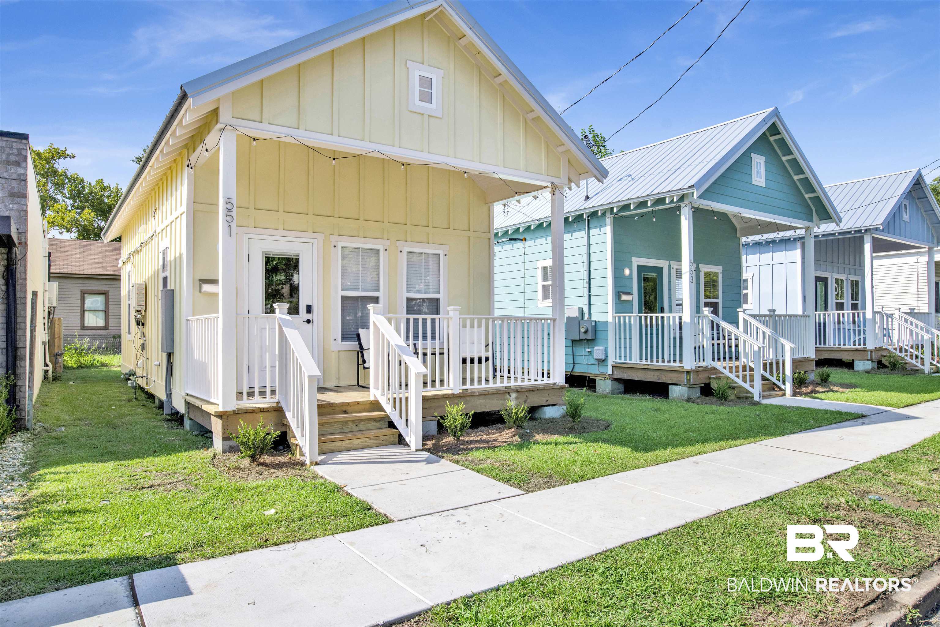 551 Congress Street Mobile, AL 36603 - Photo 3 of 19 View of front of house featuring board and batten siding, a metal roof, a front lawn, and covered porch