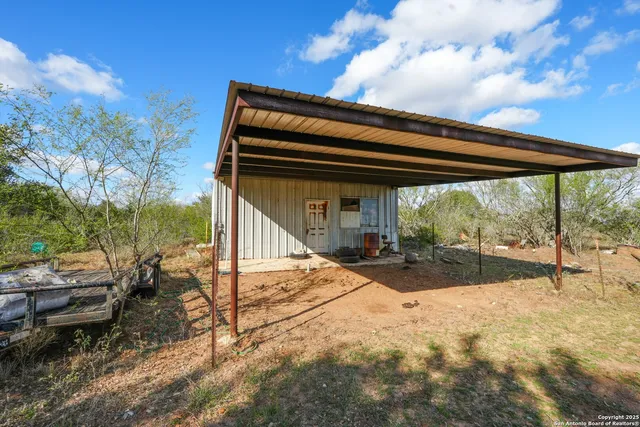 a view of a wooden door and a yard