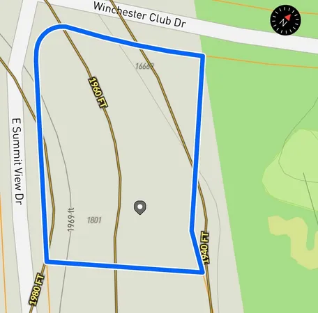 an aerial view of a house with a yard and garden