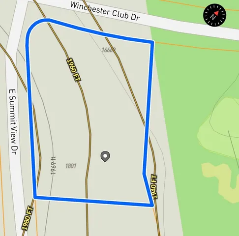 an aerial view of a house with a yard and garden