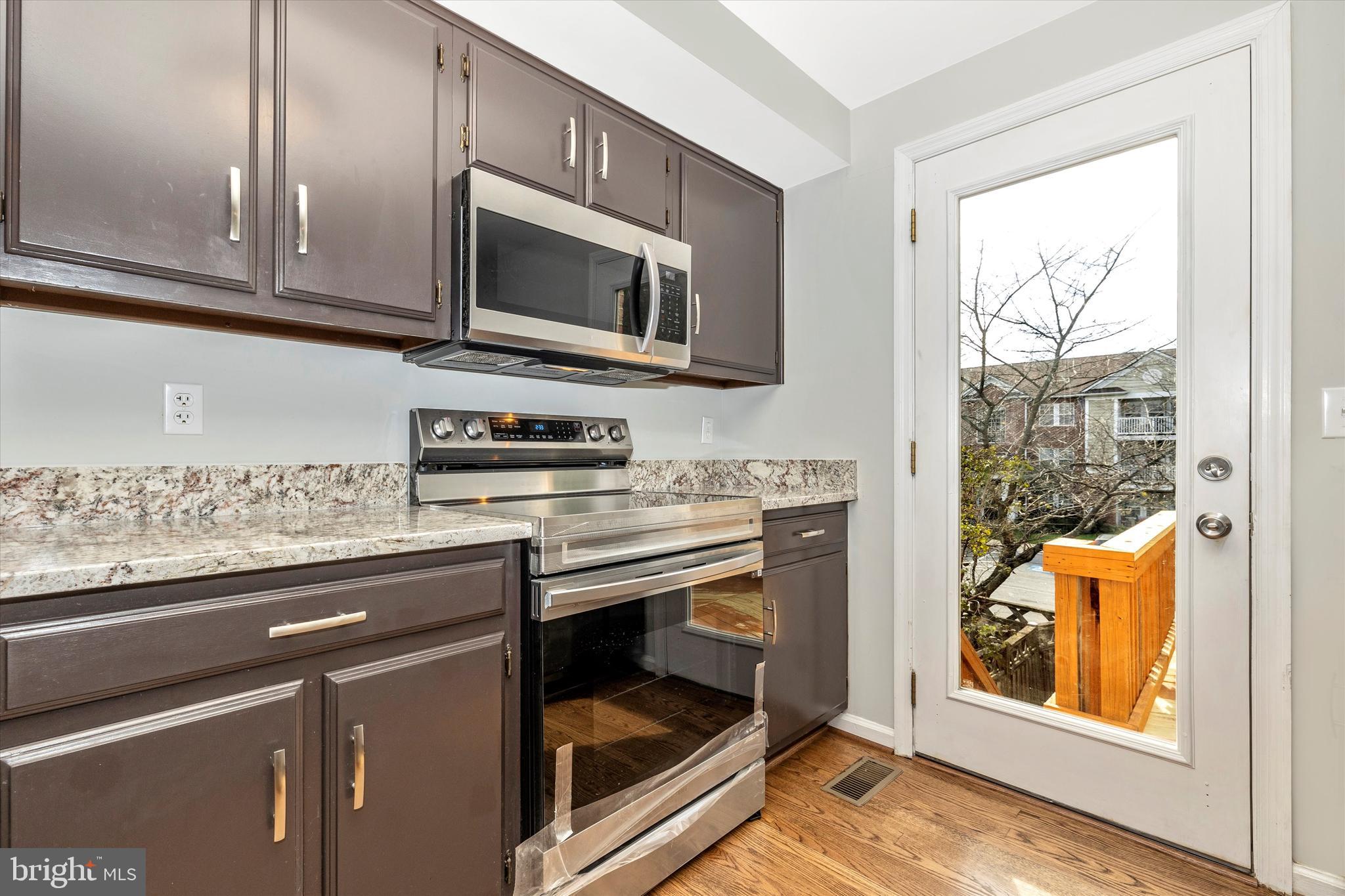 8001 Hollow Reed Court Frederick, MD 21701 - Photo 10 of 33 a kitchen with stainless steel appliances granite countertop a stove microwave and sink