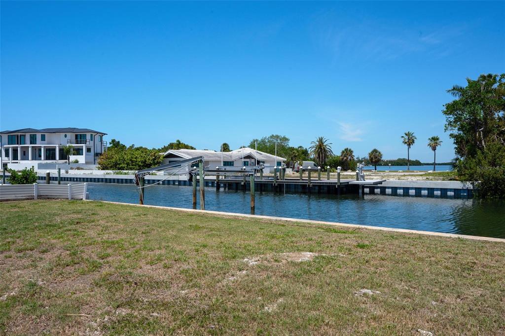 581 Rountree Drive Longboat Key, FL 34228 - Photo 12 of 50 a view of a lake with a house