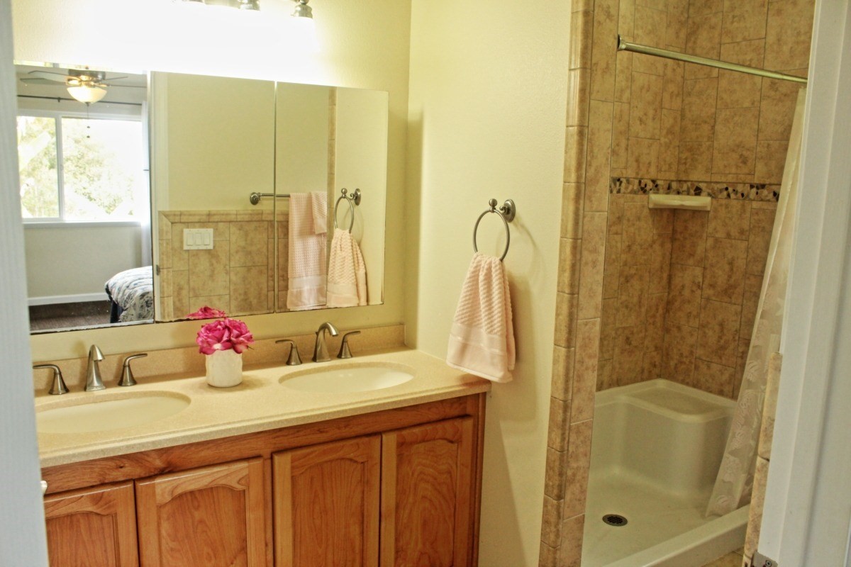 18-1354 Nichols Rd Mountain View Mountain View, HI 96771 - Photo 14 of 30 a bathroom with a double vanity sink a mirror and a shower