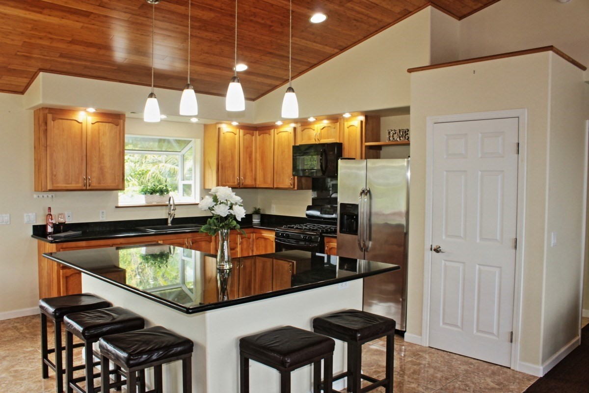 18-1354 Nichols Rd Mountain View Mountain View, HI 96771 - Photo 4 of 30 a kitchen with stainless steel appliances granite countertop a sink and cabinets