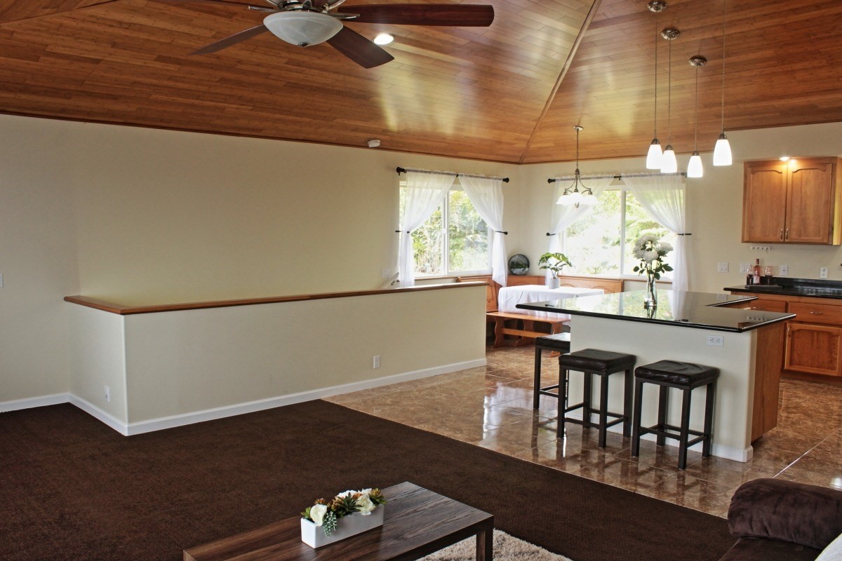 18-1354 Nichols Rd Mountain View Mountain View, HI 96771 - Photo 9 of 30 a kitchen with a table chairs and a wooden floor