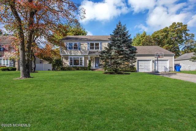 a view of house with a yard