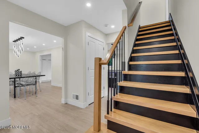 a dining room with furniture and chandelier
