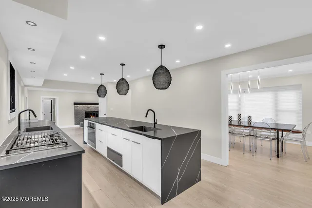 a living room with furniture a large window and a fireplace