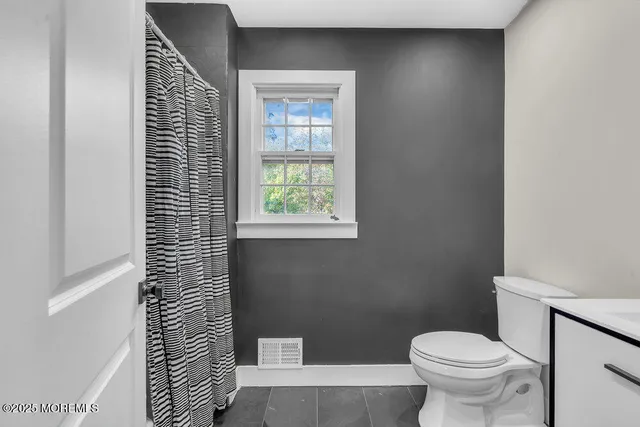 a bedroom with a bed and a view of bathroom