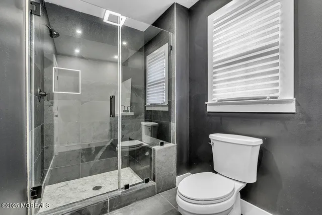 a view of a green field with trees in the background