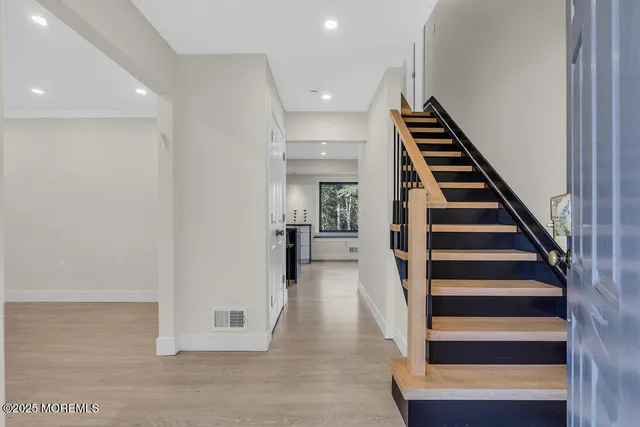 a view of an entryway with wooden floor and front door