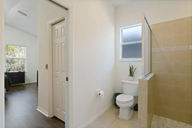 a bathroom with a toilet and a shower