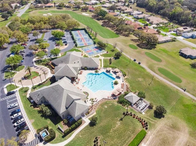 an aerial view of a house with yard swimming pool and outdoor seating