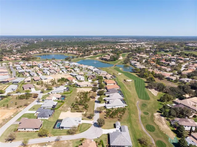 an aerial view of residential building and lake