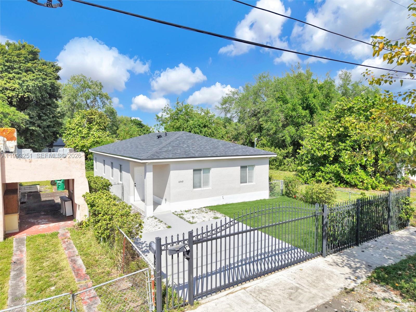 6940 Northwest 5th Place Miami, FL 33150 - Photo 1 of 42 a view of a house with a small yard and plants