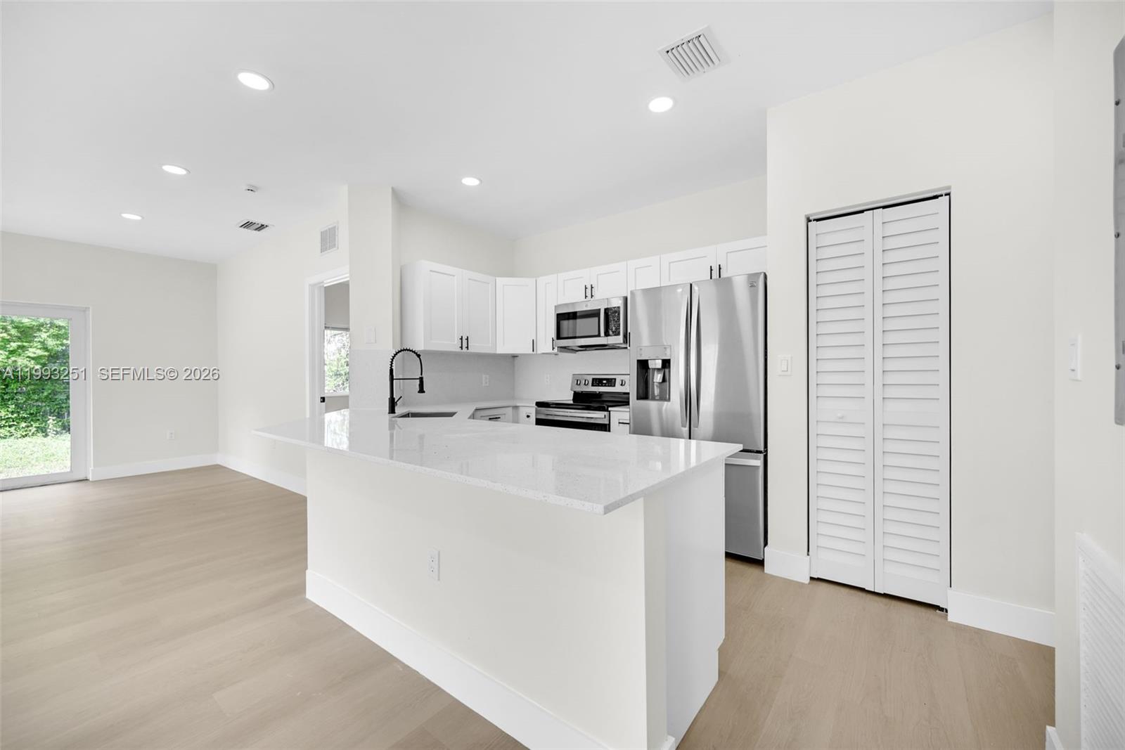 6940 Northwest 5th Place Miami, FL 33150 - Photo 17 of 42 a kitchen with stainless steel appliances a refrigerator sink and microwave