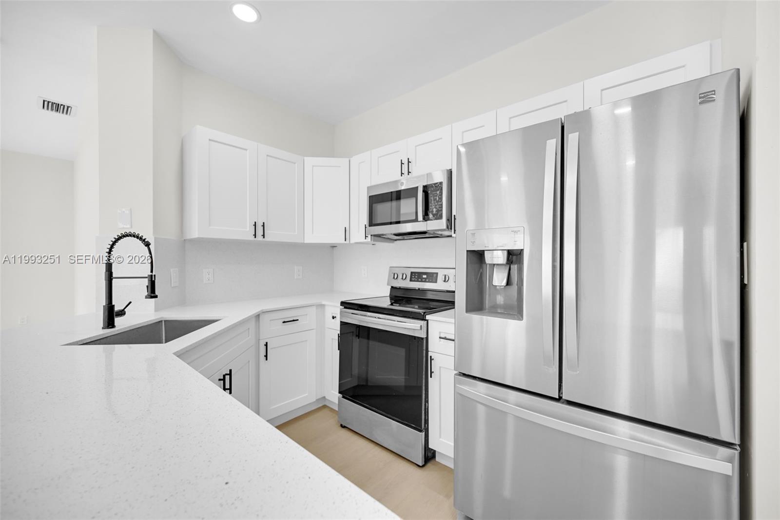 6940 Northwest 5th Place Miami, FL 33150 - Photo 18 of 42 a kitchen with stainless steel appliances a refrigerator sink and microwave