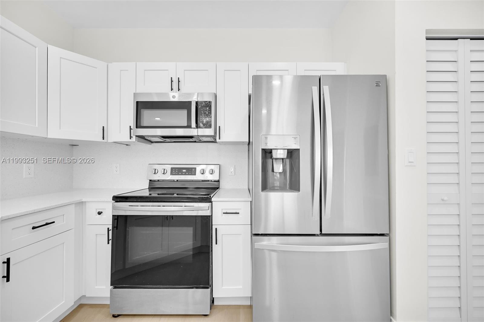 6940 Northwest 5th Place Miami, FL 33150 - Photo 19 of 42 a white refrigerator freezer and a stove in a kitchen