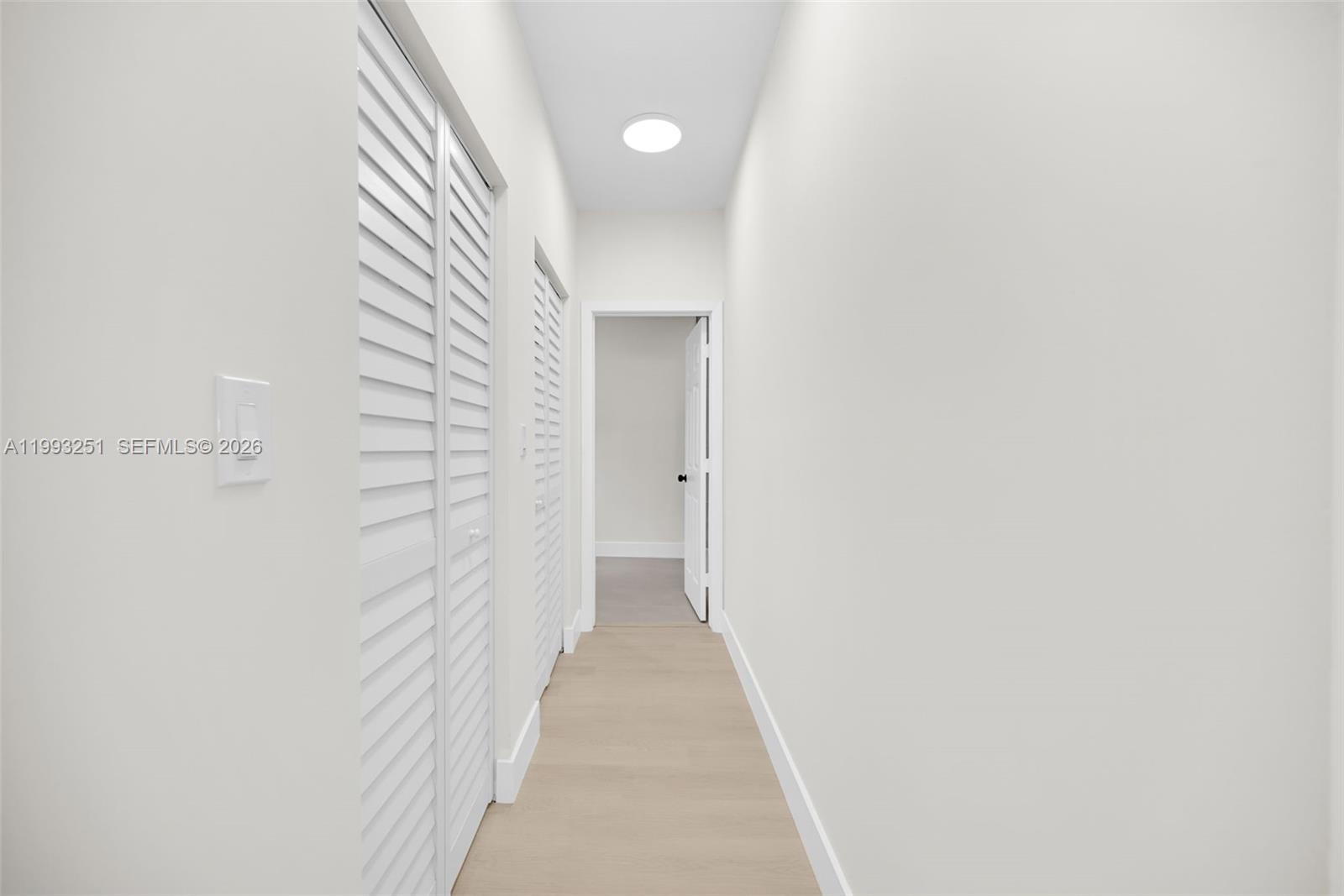 6940 Northwest 5th Place Miami, FL 33150 - Photo 23 of 42 a view of a hallway with wooden floor and a bathroom