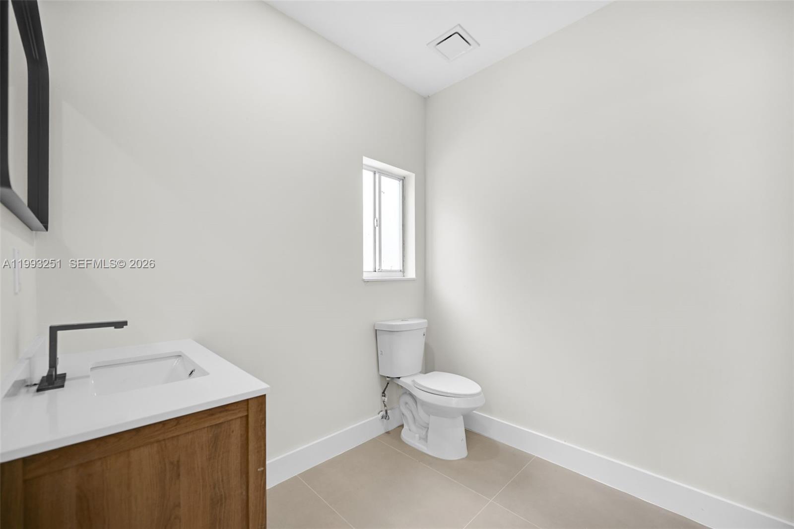 6940 Northwest 5th Place Miami, FL 33150 - Photo 25 of 42 a bathroom with a sink toilet and window