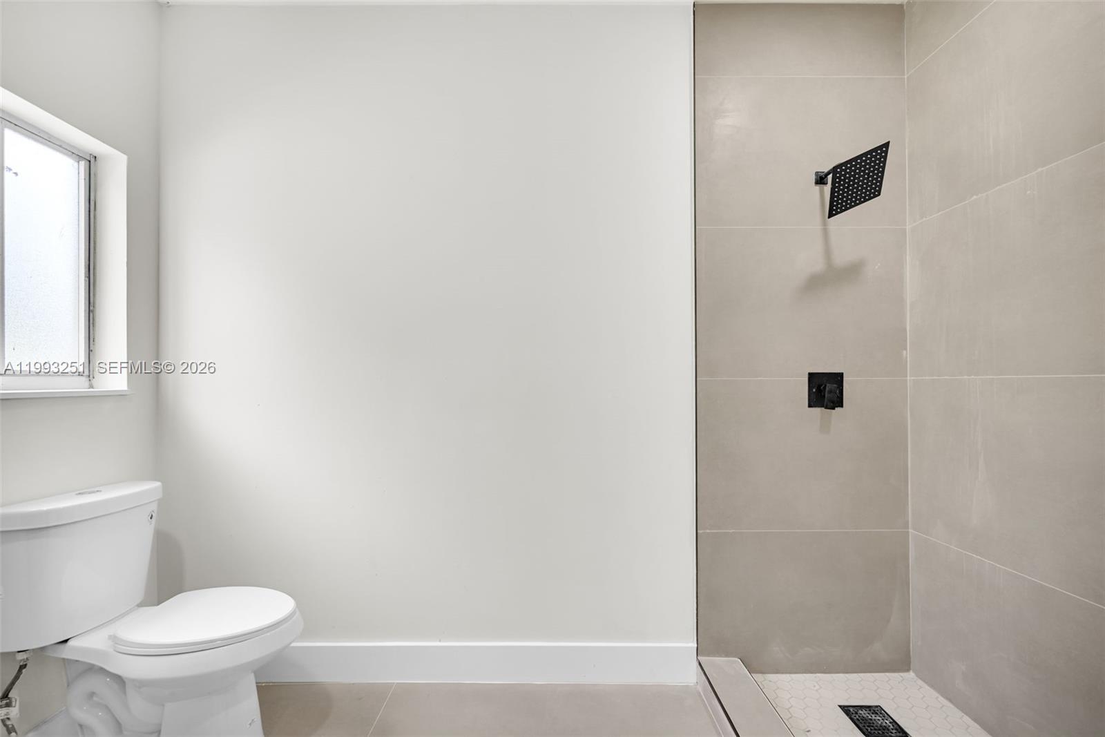 6940 Northwest 5th Place Miami, FL 33150 - Photo 26 of 42 a bathroom with a toilet and a shower