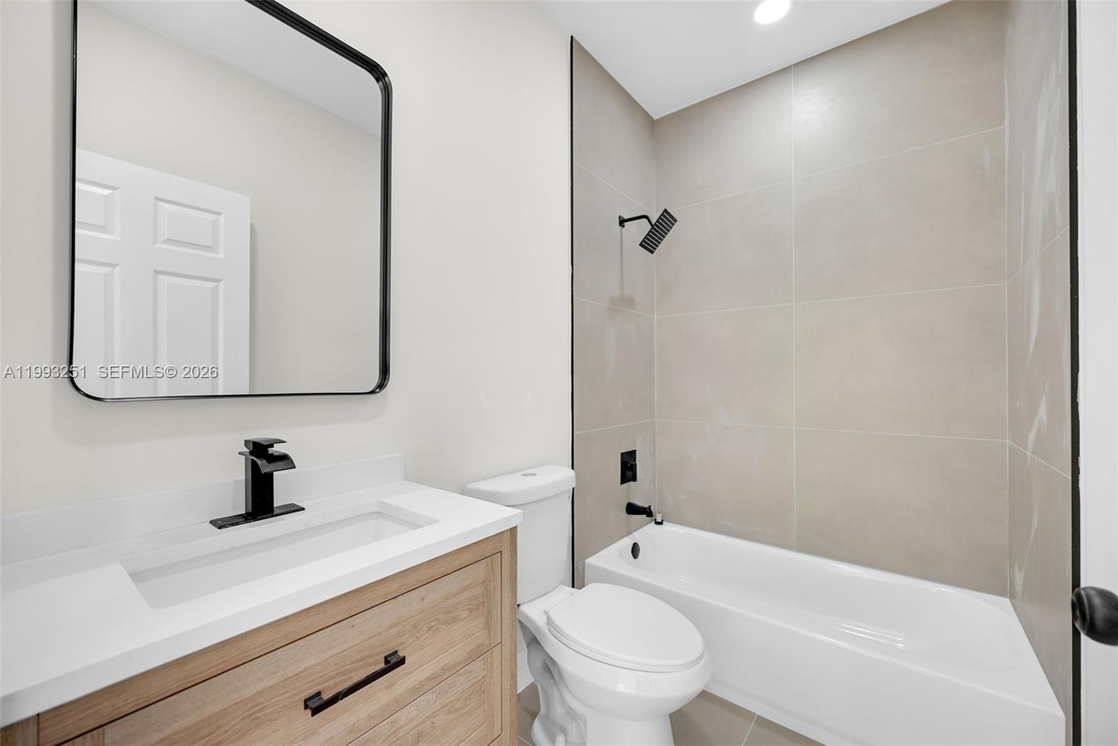 6940 Northwest 5th Place Miami, FL 33150 - Photo 34 of 42 a bathroom with a sink a toilet and a mirror