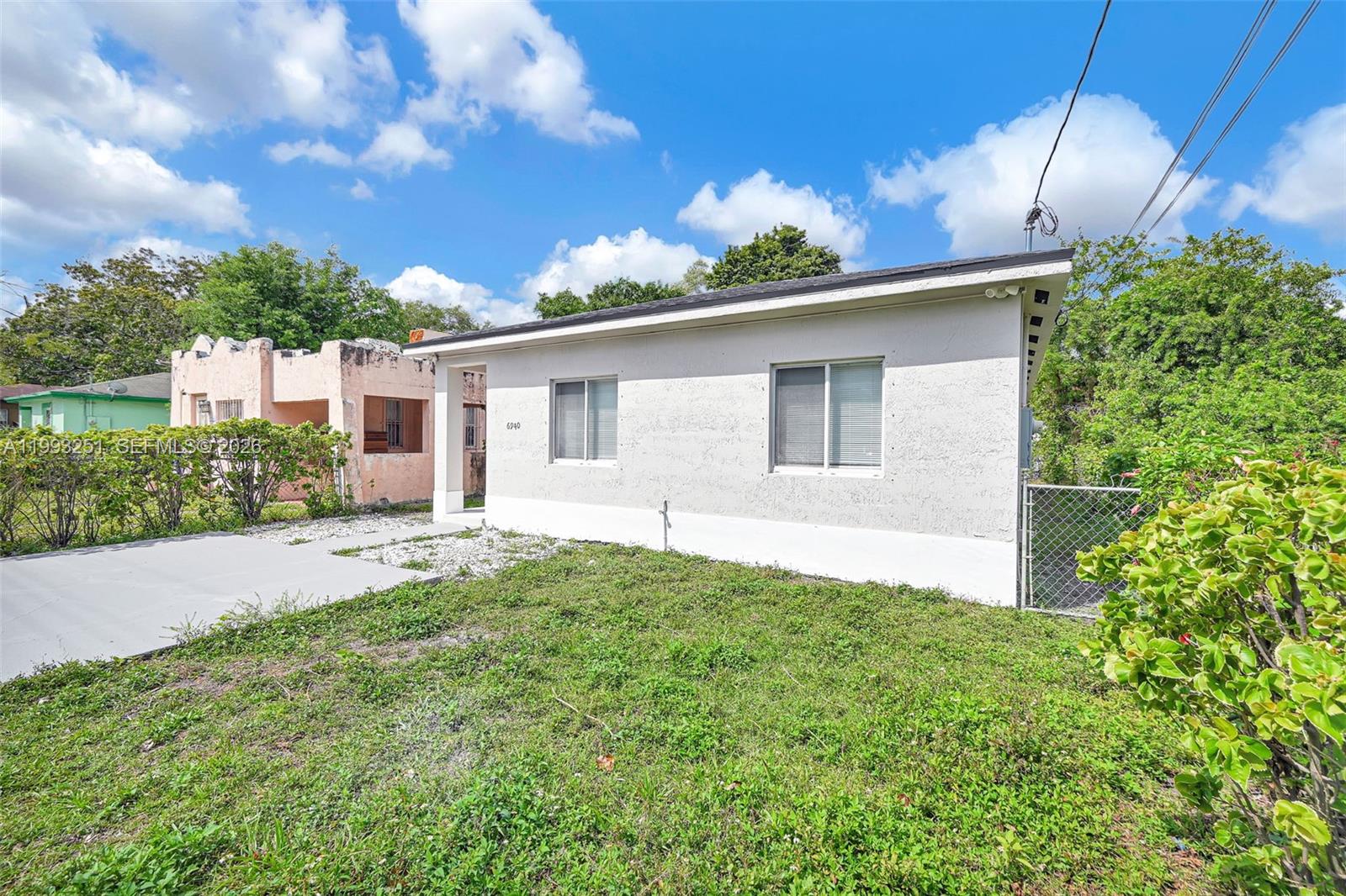 6940 Northwest 5th Place Miami, FL 33150 - Photo 4 of 42 a front view of house with yard and trees in the background