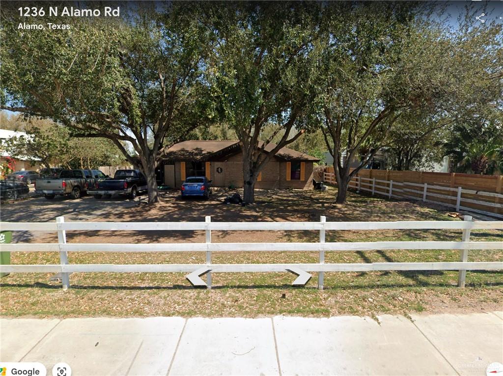 a view of a house with a large tree