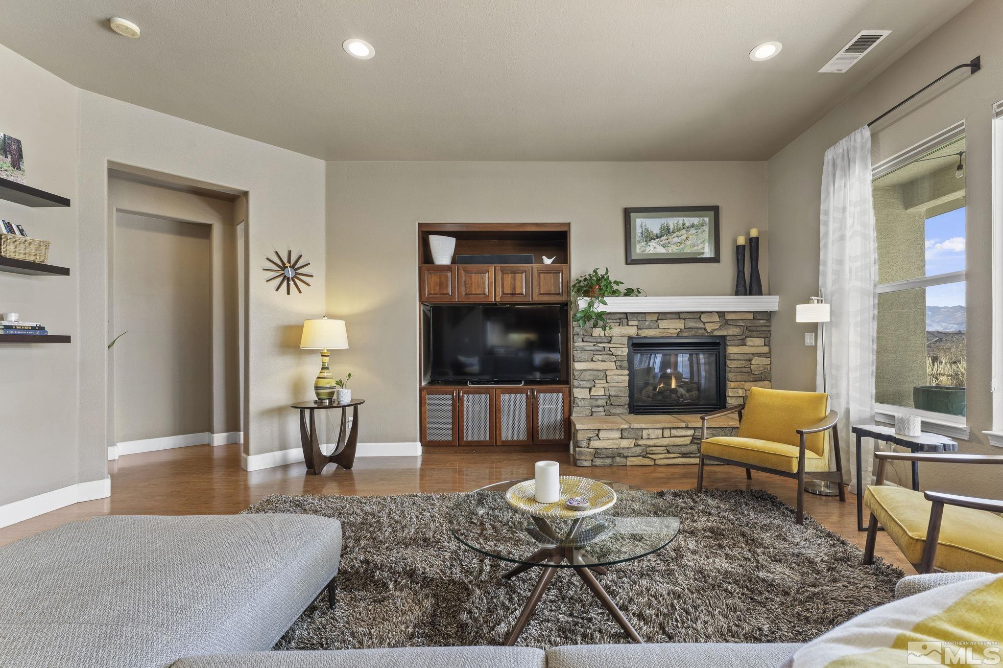 2751 Robb Drive Reno, NV 89523 - Photo 9 of 40 a living room with furniture a flat screen tv and a fireplace