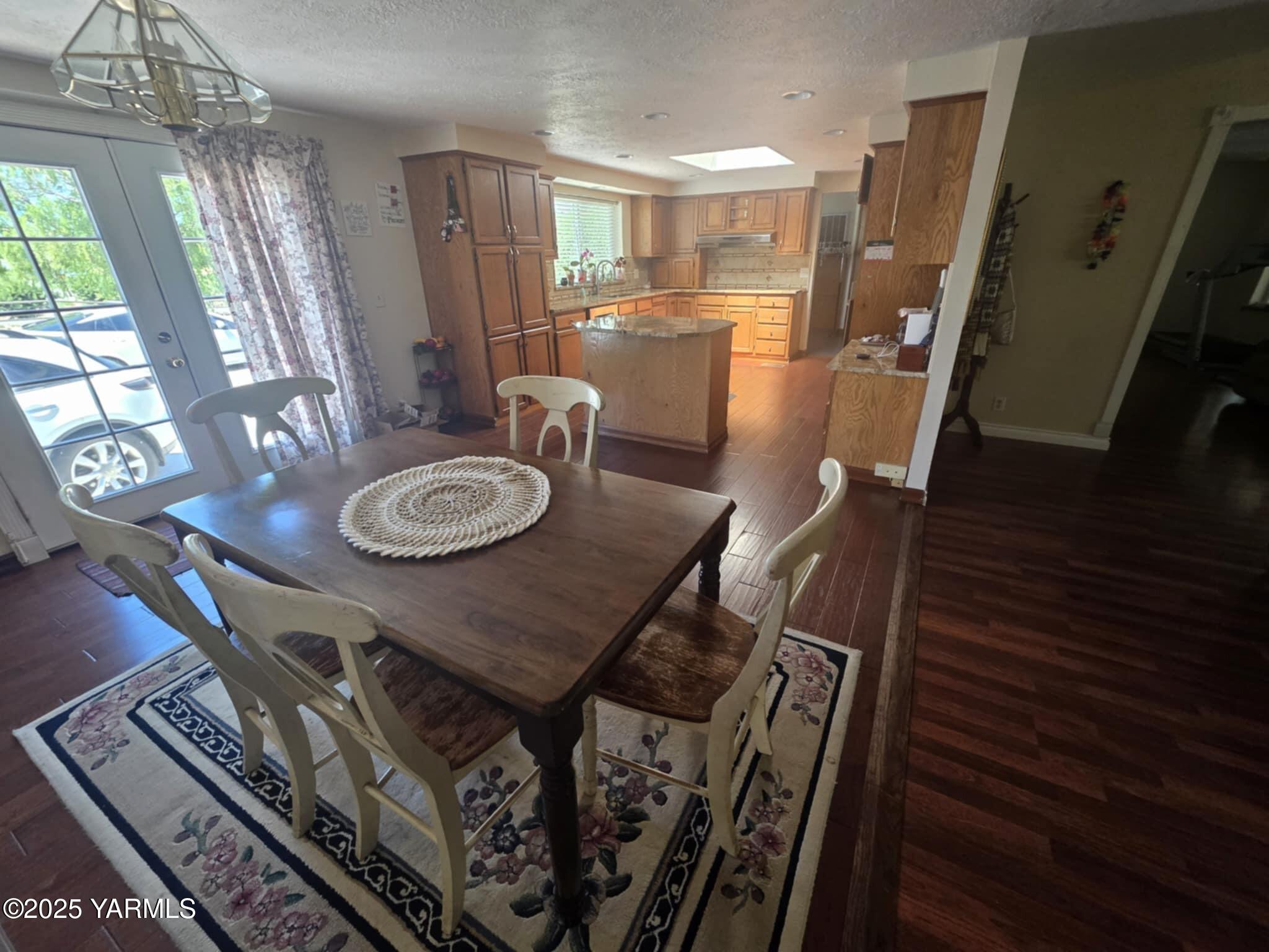 5202 Norman Road Yakima, WA 98901 - Photo 26 of 48 a view of a dining room with furniture wooden floor and chandelier