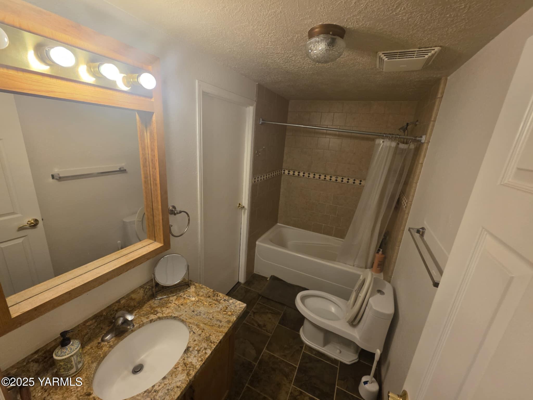5202 Norman Road Yakima, WA 98901 - Photo 35 of 48 a bathroom with a granite countertop sink toilet and shower