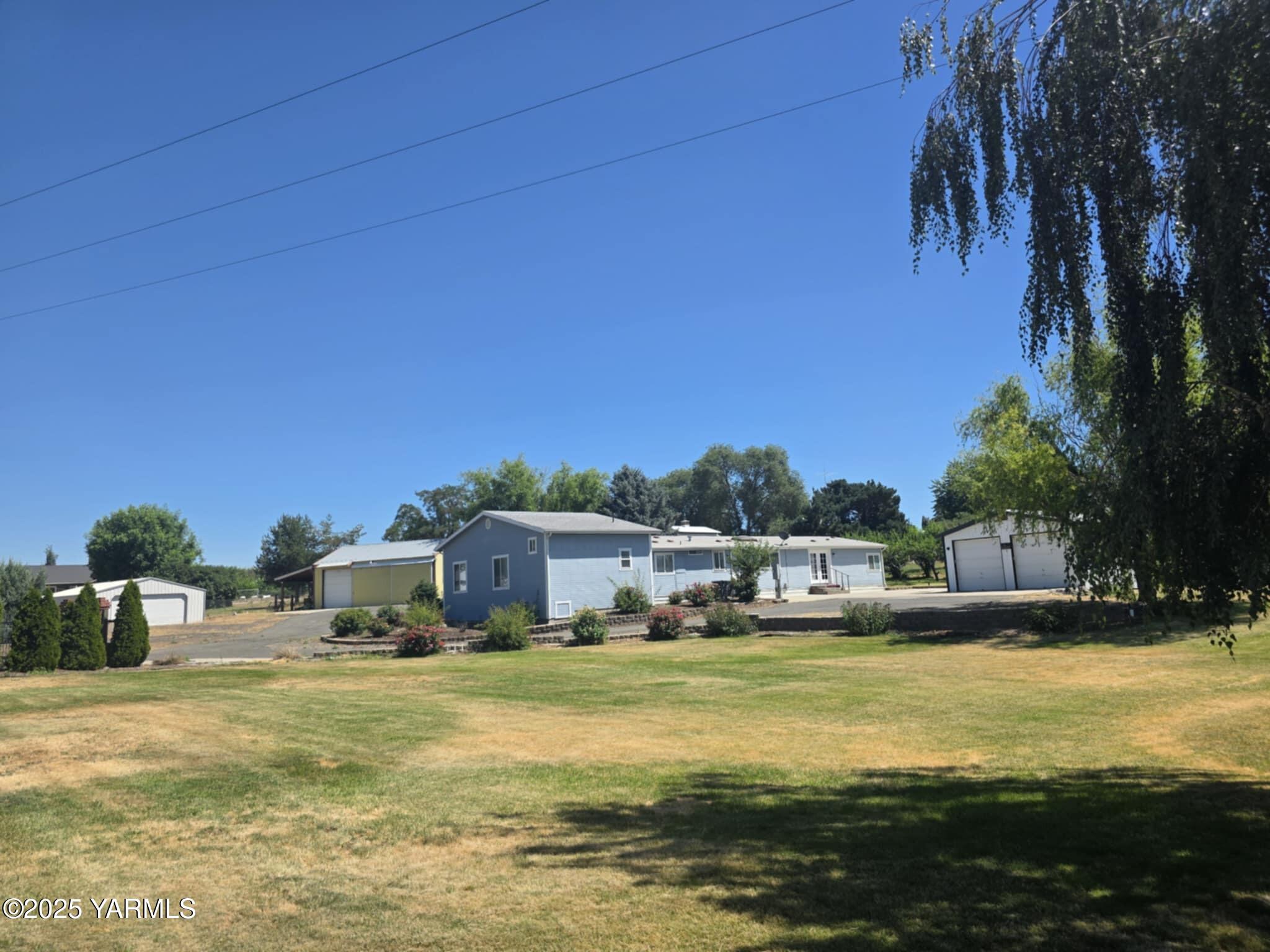 5202 Norman Road Yakima, WA 98901 - Photo 5 of 48 a house view with swimming pool next to a yard