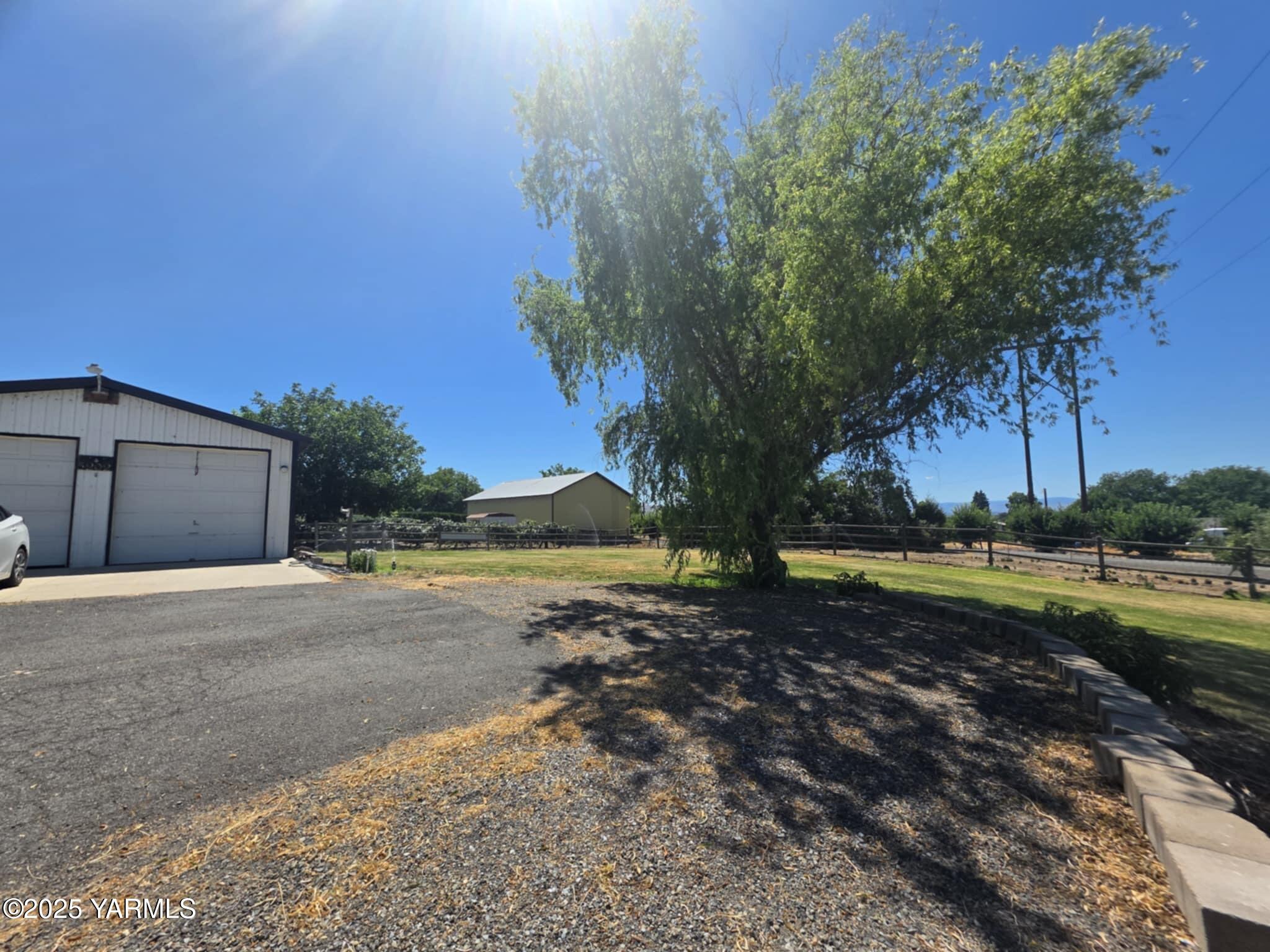 5202 Norman Road Yakima, WA 98901 - Photo 8 of 48 a view of a yard with a house