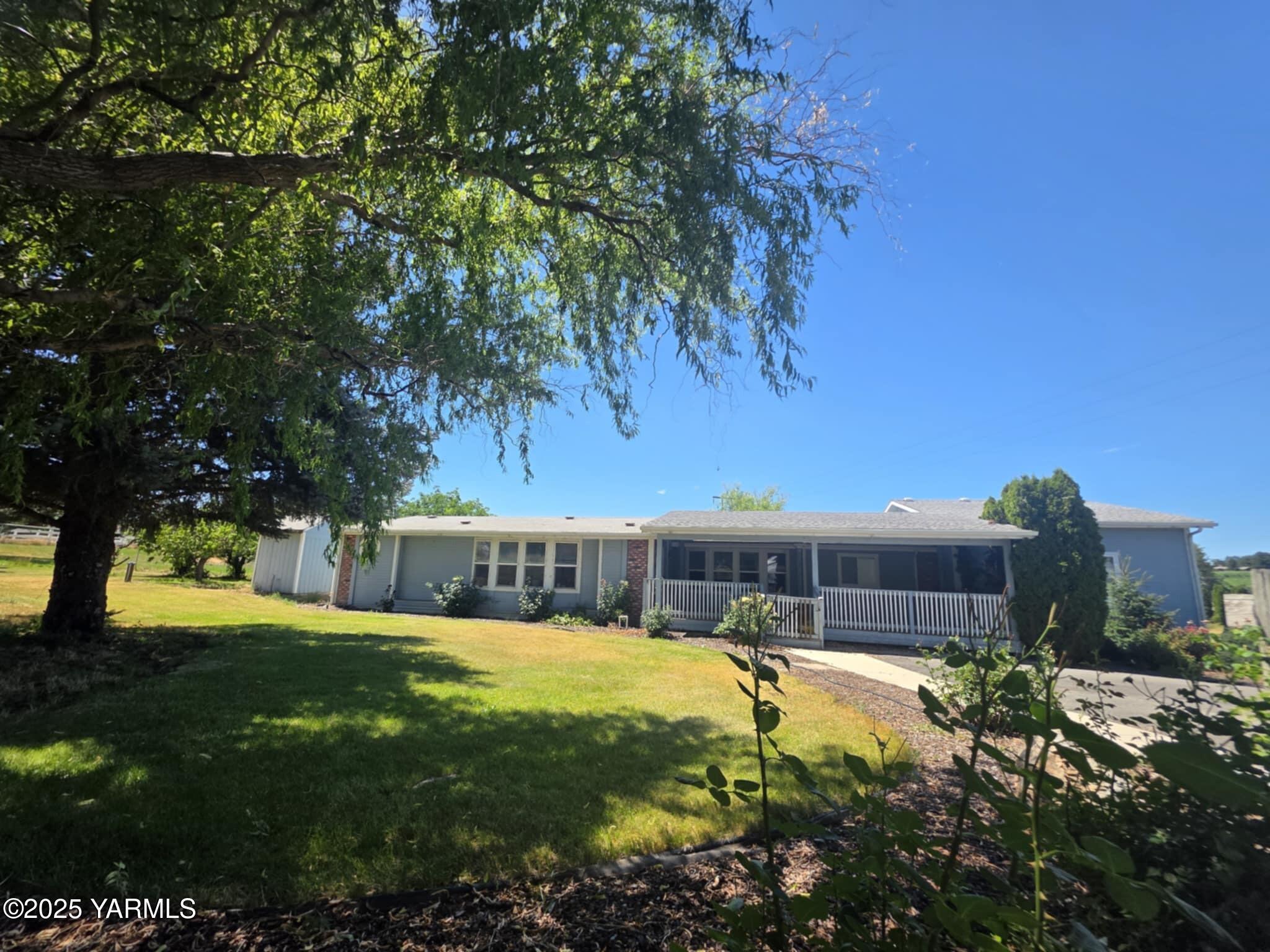 5202 Norman Road Yakima, WA 98901 - Photo 10 of 48 a view of swimming pool with lawn chairs and large trees